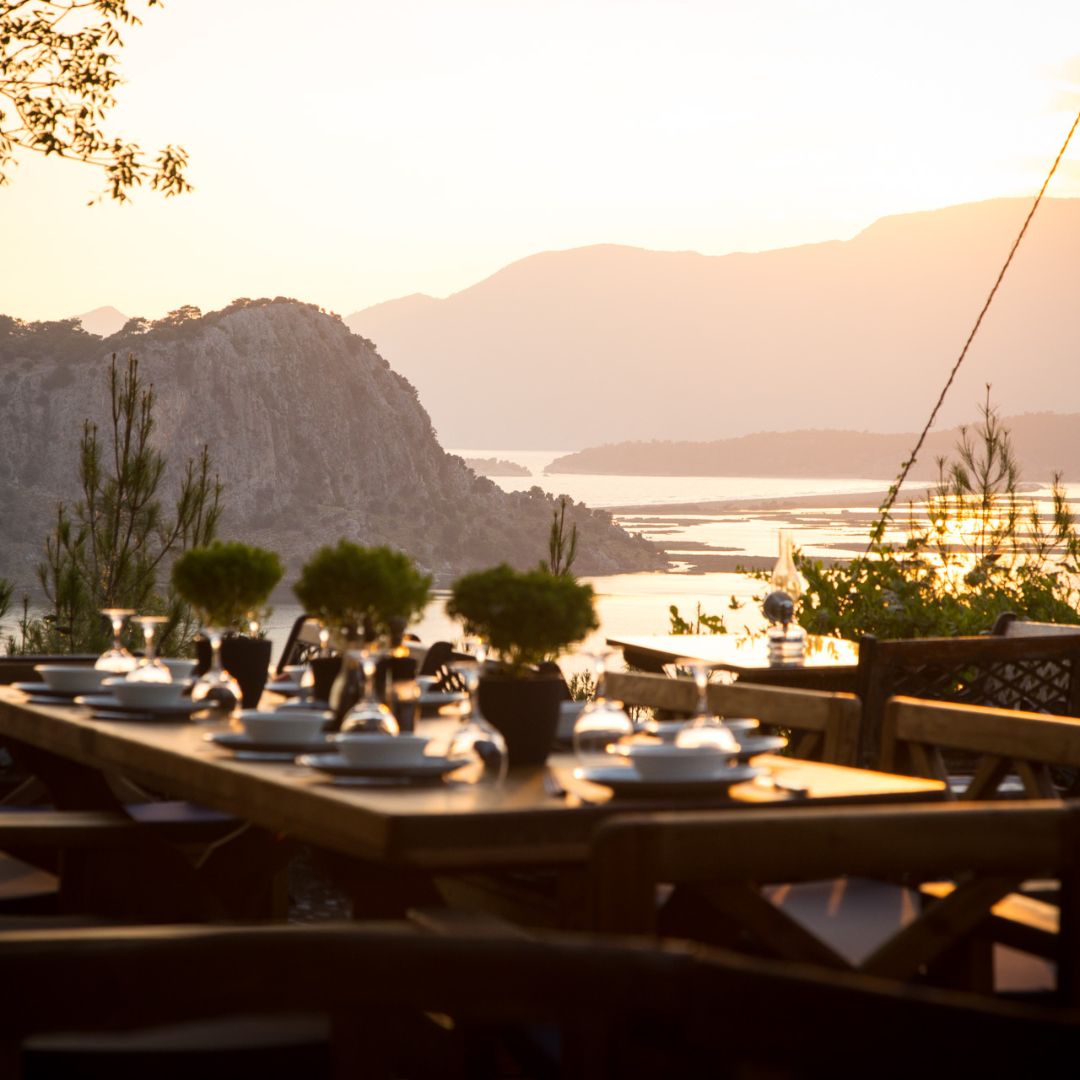 dinner table at sunset with view over lagoon